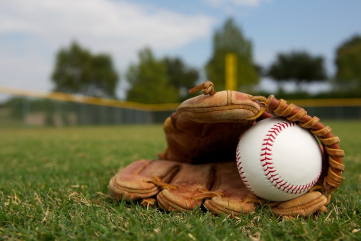 baseball in glove laying on field