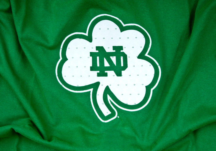 Green Notre Dame flag with an Irish shamrock and Notre Dame logo on it